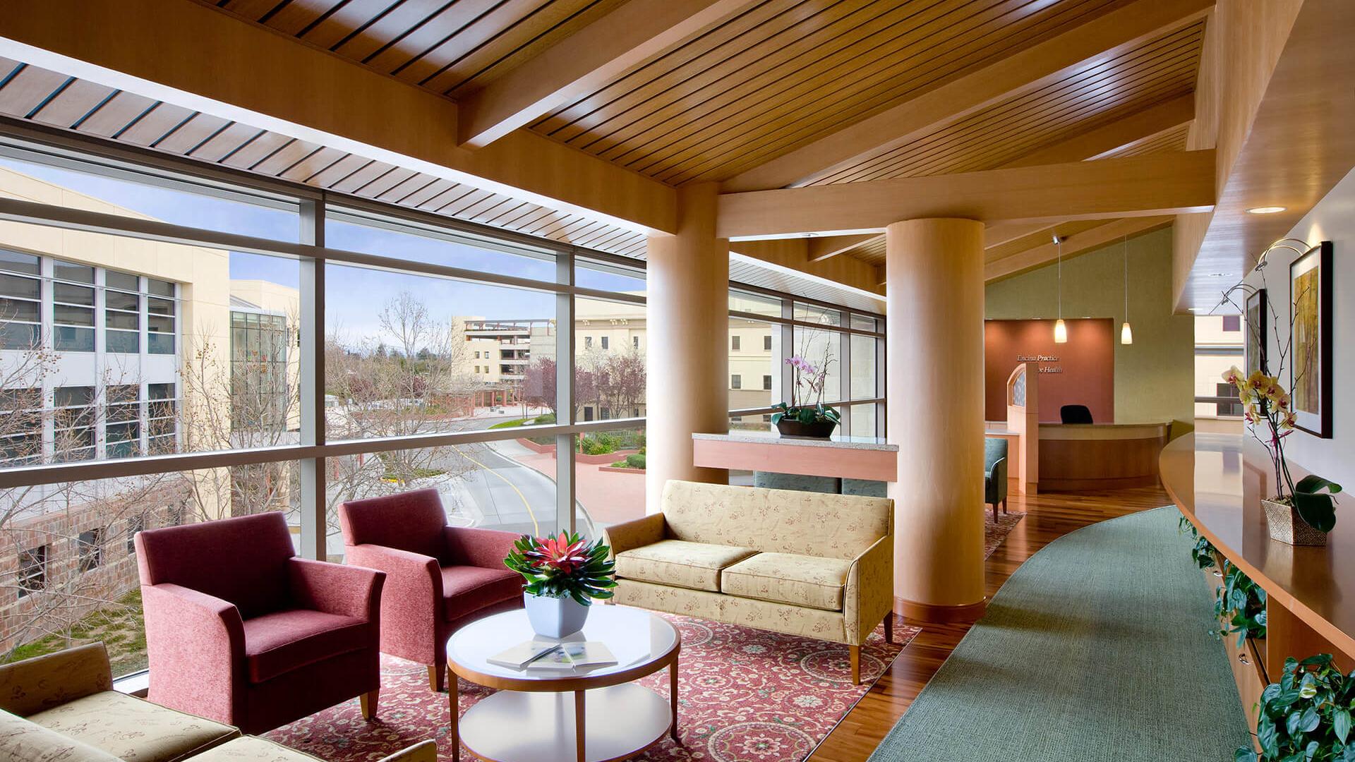Interior patient waiting area with warm finishes and views to the outside